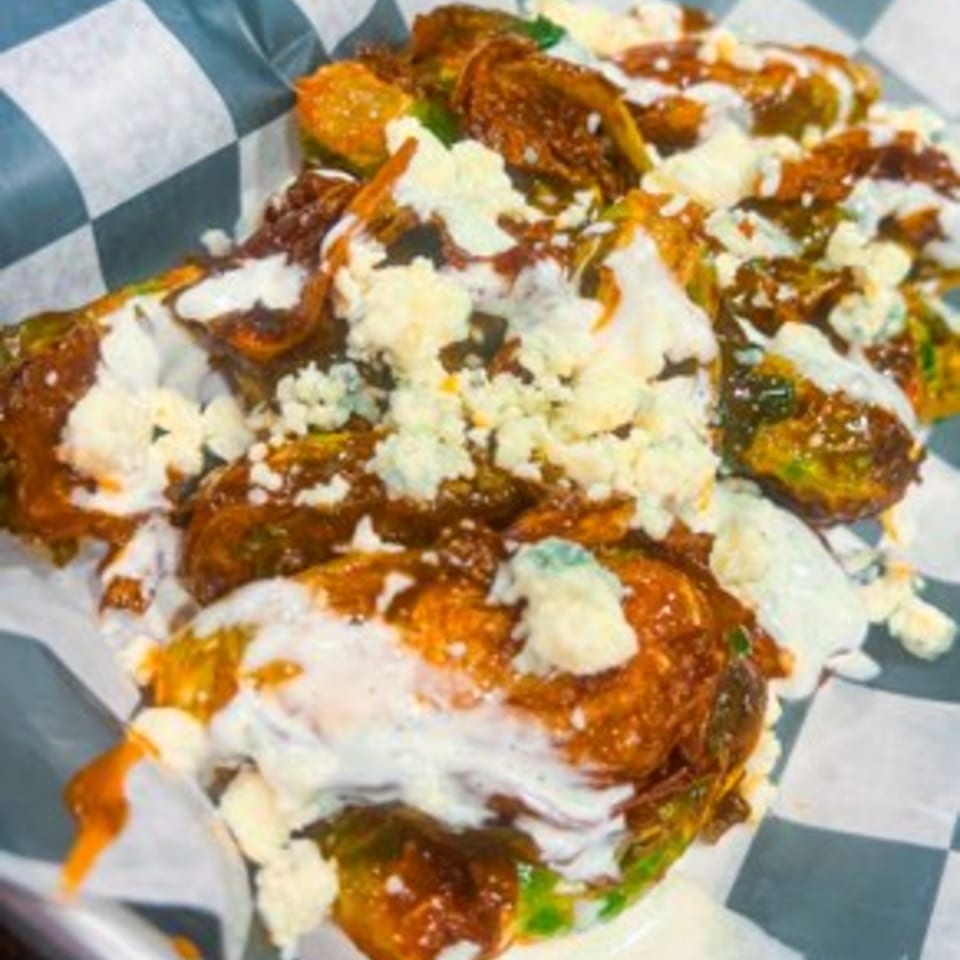 Steel House's crispy brussels sprouts with buffalo sauce, blue cheese crumbles, and ranch dressing.